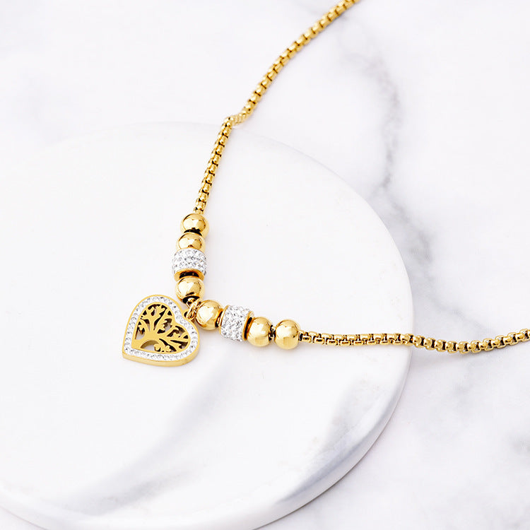 Collier “Arbre du Cœur” – Pendentif doré & perles strassées