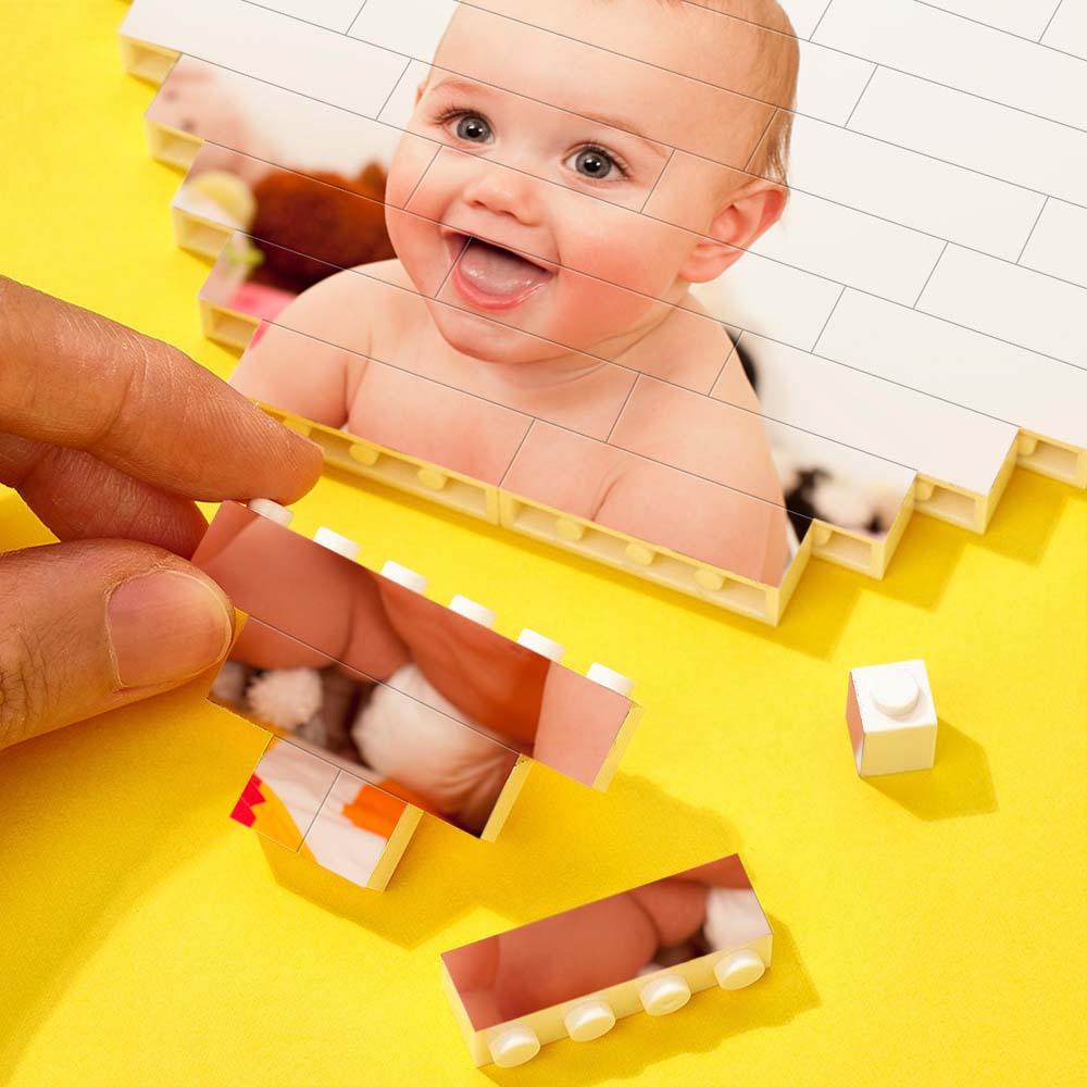 Assembling custom heart-shaped photo block with baby picture, DIY Children's Day gift. Interlocking brick puzzle.
